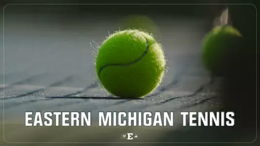 Tennis ball sits on the court with the words Eastern Michigan Tennis printed on the graphic