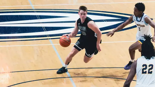 Max Booher preparing to throw a basketball downward with his right foot planted and left foot elevated at University of Windsor, Aug. 15, 2026