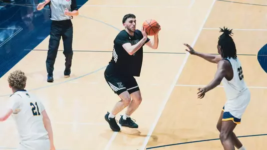 Omar Suleiman pretending to shoot a basketball before dribbling at University of Windsor, Aug. 15, 2026