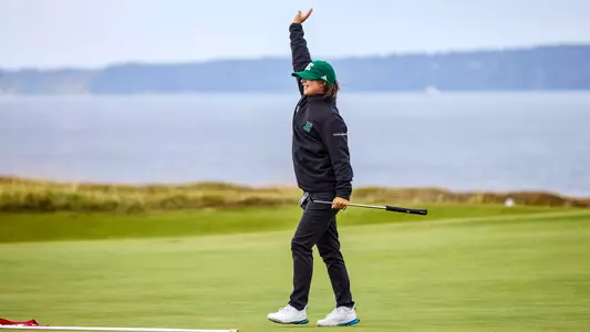 Savannah de Bock waves to her teammates after sinking a putt at Chambers Bay GC, Sept. 14, during the Leadership & Golf Invitational in University Place, Wash.