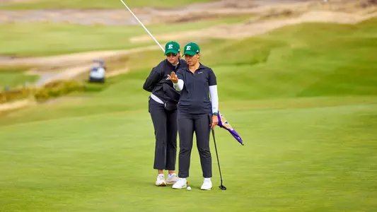 Constanza Quiroga chats with Caterina Don on the putting green at Chambers Bay