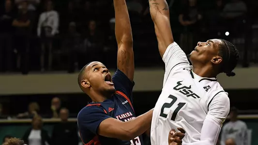 Nov 10, 2017; Tampa, FL, USA; Florida Atlantic Owls forward Jailyn Ingram (15) gets a shot off over South Florida Bulls forward Tulio Da Silva (21) in the first half at USF Sun Dome. Mandatory Credit: Jonathan Dyer-USA TODAY Sport