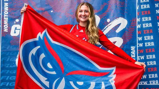 2026-27 Women's Basketball Signee Skyla Tuthill smiling and holding Florida Atlantic flag