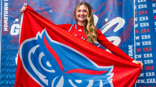 2026-27 Women's Basketball Signee Skyla Tuthill smiling and holding Florida Atlantic flag