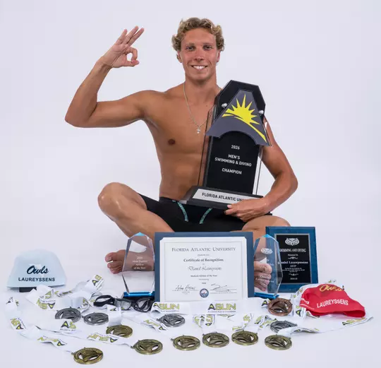Daniel Laureyssens sitting on the floor with medals