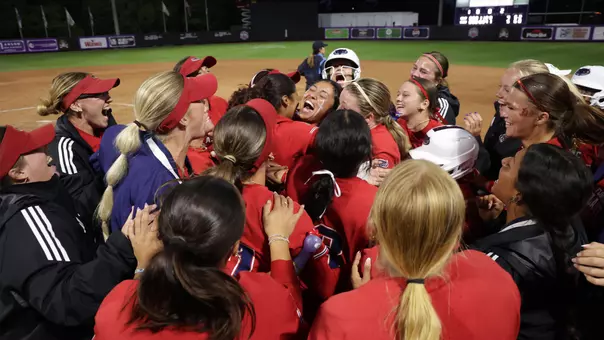 Softball celebrating with Jesiana Mora after hitting the walk-off RBI single against No. 5 Charlotte in the American Conference Quarterfinals
