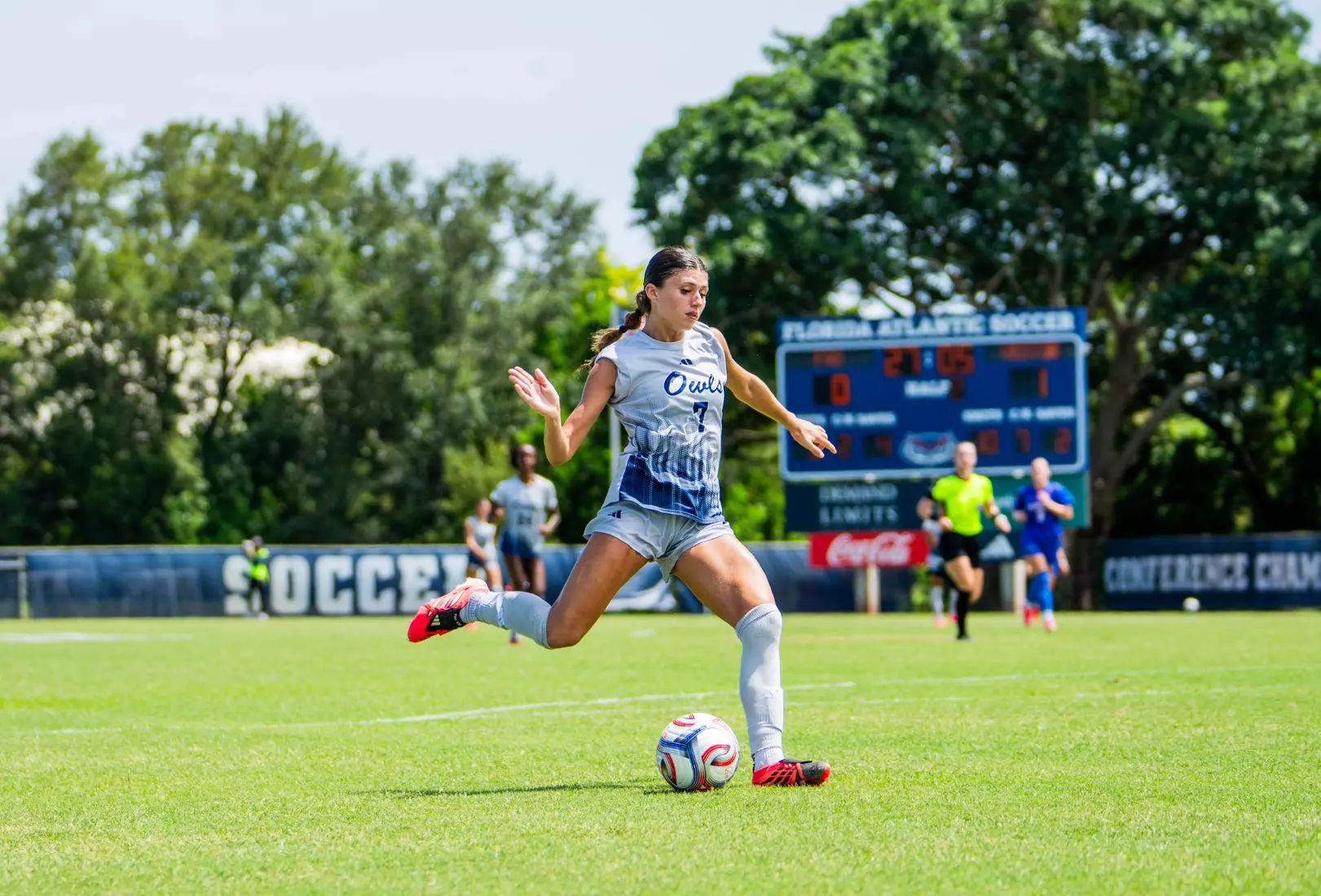 Women's soccer's Hailey Santiago kicking the ball into the goal versus Florida.