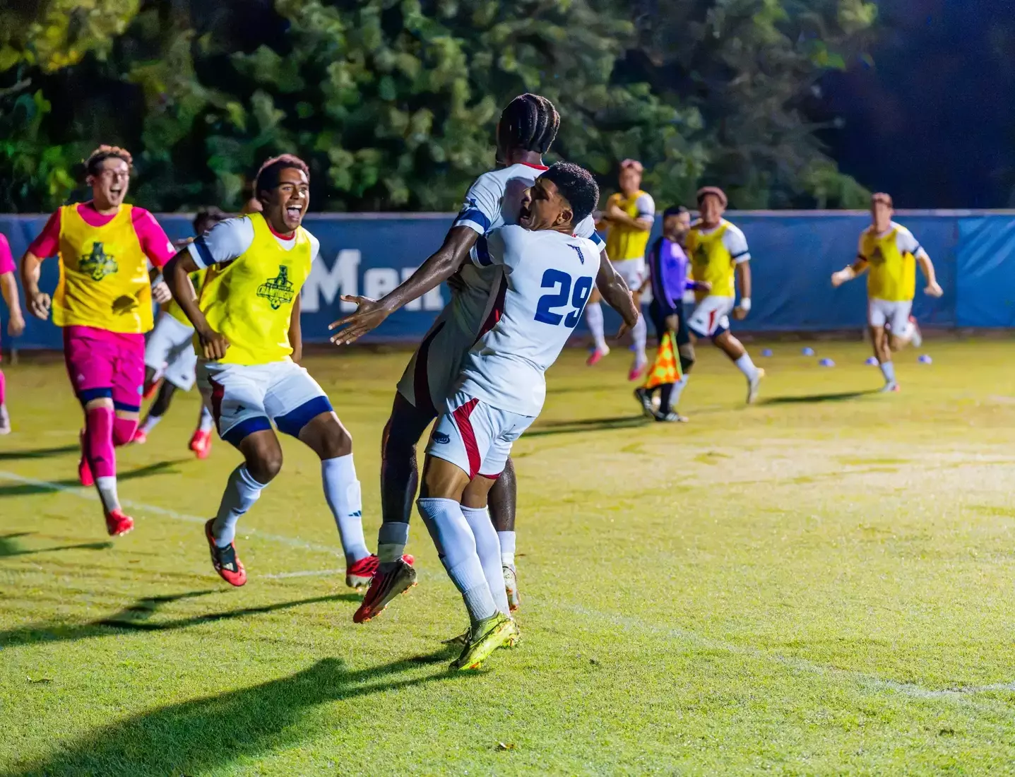 Men's soccer's Michel Tentchou being hoisted by his teammates after scoring the 1-1 equalizer in the Owls, American Conference opener versus Charlotte.