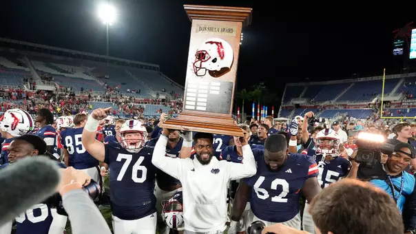 The Owls celebrating with the Shula Bowl trophy