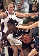 Illinois' Tauja Catchings runs between Connecticut's defense in the first half of their game in Storrs, Conn. on Tuesday.