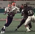 Illinois halfback Steve Havard moves around Virginia linebacker Yubrenal Isabelle to score a touchdown in the first half of the Micronpc.com Bowl.
