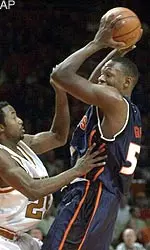Illinois forward Marcus Griffin, left, looks to pass the ball past the defense of Texas guard Darren Kelly.