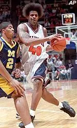Illinois' Sergio McLain squeezes past two Michigan defenders in the first half of Wednesday's game.
