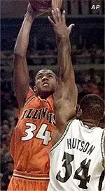 Illinois' Brian Cook puts up a shot over Michigan State's Andre Hutson during the Illini's loss in the Big Ten title game.