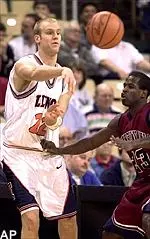 Lucas Johnson passes the ball as Pennsylvania's Michael Jordan defends during the first half of the 68-58 Illini victory Wednesday.