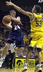 Illinois' Sean Harrington, left, looks to pass around Iowa's Sean Sonderleiter (53) during the first half, Thursday.