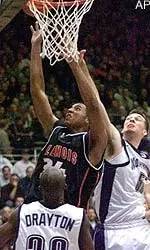 Illinois' Brian Cook, center, goes up for a shot between Northwestern's Aaron Jennings, right and Collier Drayton in the first half in Evanston, Ill., Wednesday.