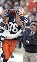 Illinois' Aaron Moorehead catches a pass as Penn State's Richard Gardner defends while Penn State coach Joe Paterno, right, looks on at Memorial Stadium.