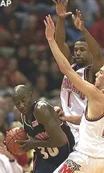 Frank Williams is pressured by Maryland's Steve Blake and Byron Mouton in the first half Tuesday.