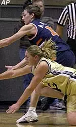 Illinois' Allison Curtin and Purdue's Kelly Komara race for a loose ball during the first half of Thursday's game.