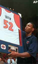 Illinois' Marcus Griffin holds a framed jersey during Senior Day ceremonies before the Iowa-Illinois basketball game on Saturday. Griffin scored 17 points as Illinois won 89-63.