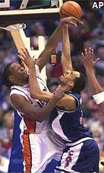 Arizona's Loren Woods, center, has his shot blocked by Illinois' Marcus Griffin during the first half of Sunday's regional final.