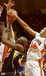 Iowa's Reggie Evans tries to shoot amid the defense of Illinois' Brian Cook, right, and Robert Archibald, left, during the first half in Champaign.