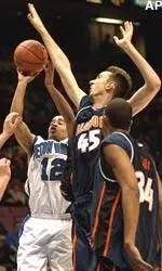 Illinois center Nick Smith tries to block Seton Hall guard Andre Barrett's shot during the first half.
