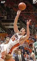 Illinois' Damir Krupalija falls over Michigan State's Adam Ballinger while attempting a basket in the first half of their game Sunday.