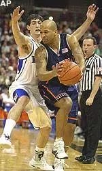 Cory Bradford looks to pass around Kansas' Kirk Hinrich in the first half during the NCAA Midwest Regional semifinal.