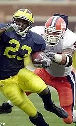 Linebacker Matt Sinclair tries to tackle Michigan running back Chris Perry during the first quarter.