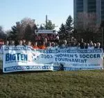 The Fighting Illini pose with the trophy and the Big Ten Tournament banner after winning Illinois' first ever conference soccer tournament title on Sunday.