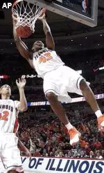 Roger Powell dunks the ball as teammate Brian Randle looks on during the first half.