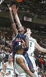 Dee Brown goes in for a layup over Michigan State's Maurice Ager, bottom, and Erazem Lorbek.
