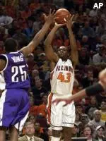 Northwestern's Jitim Young tries to block a 3-point shot by Illinois' Roger Powell during the first half Saturday at the United Center. Powell led the Illini with 20 points