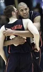 Brian Cook and Sean Harrington celebrate the Illini's 82-79 win over Michigan.