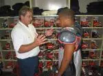 Incoming freshman running back Marcus Mason gets fitted for equipment during reporting day on Tuesday.