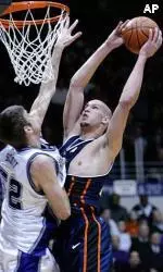 James Augustine takes a shot over Northwestern's Vince Scott during the first half.