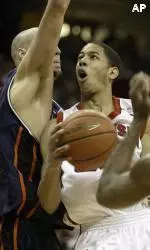 James Augustine challenges Wisconsin's Devin Harris as he takes it to the hoop.