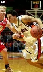 Deron Williams tries to drive past Ohio State's Nick Dials during the first half.