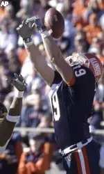 Illinois' Mark Kornfeld (19) tries for a reception over Iowa's Marcus Paschal (25).