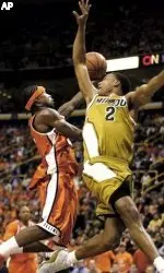 Dee Brown shoots behind Missouri's Jason Conley duing the first half.
