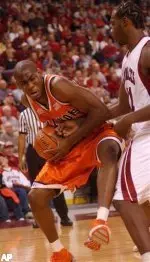 Roger Powell is pressured by Arkansaas forward Charles Thomas during the first half.