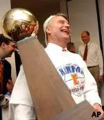 Illinois Head Coach Bruce Weber is all smiles as he holds the Big Ten Championship trophy. The Illini earned their first outright title in 52 years with their victory at Ohio State on Sunday.