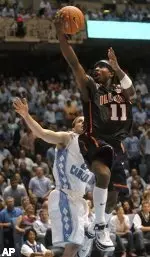 Dee Brown shoots over North Carolina's Wes Miller (22) in the second half of Illinois' 68-64 win over North Carolina Tuesday night. (AP Photo)