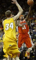 Dee Brown drives to the basket past Iowa's Erek Hansen during the first half.