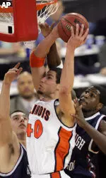 James Augustine puts up a shot against Fairleigh Dickinson's Andrea Crosariol, left, and Andre Harris.