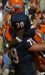 Illinois' Pierre Thomas is lifted off the ground by teammate James Ryan after scoring in overtime against Rutgers.