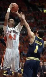 Illinois' Brian Randle (42) puts up a three point shot in front of Michigan's Jerret Smith (1) in first half college basketball action at the Assembly Hall in Champaign, Il, on Saturday Jan. 14, 2006. (AP Photo/John Dixon)