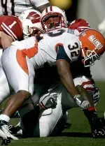 Wisconsin's P.J. Hill is hit by Illinois' Justin Harrison (32) during the second half of a football game Saturday, Oct. 28, 2006, in Madison, Wis. Hill was injured on the 7 yard run. Wisconsin won 30-24. (AP Photo/Andy Manis)